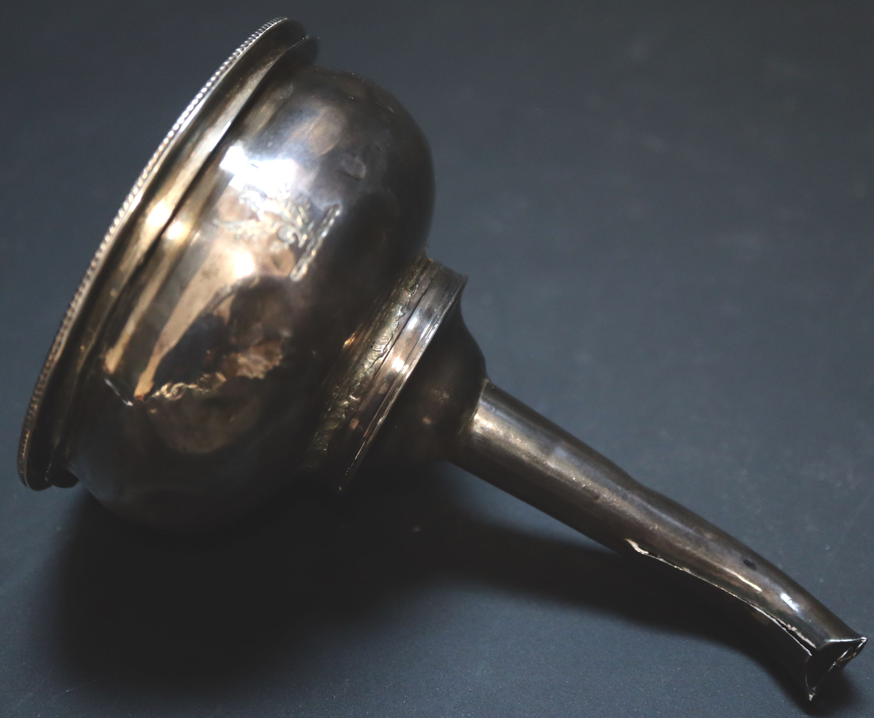 A George III silver wine funnel, 11.7cm, 90 grams (a.f.).